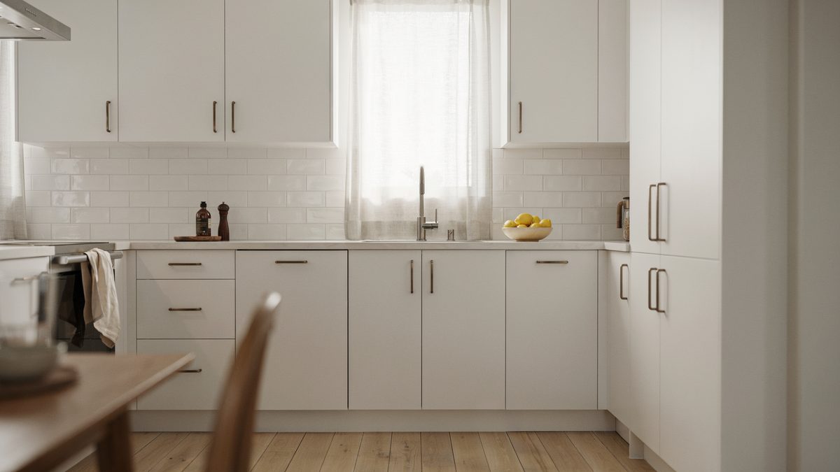 Simple white kitchen with subway tile backsplash and clean porcelain countertops