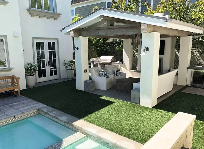 Backyard with pool cabana and artificial grass