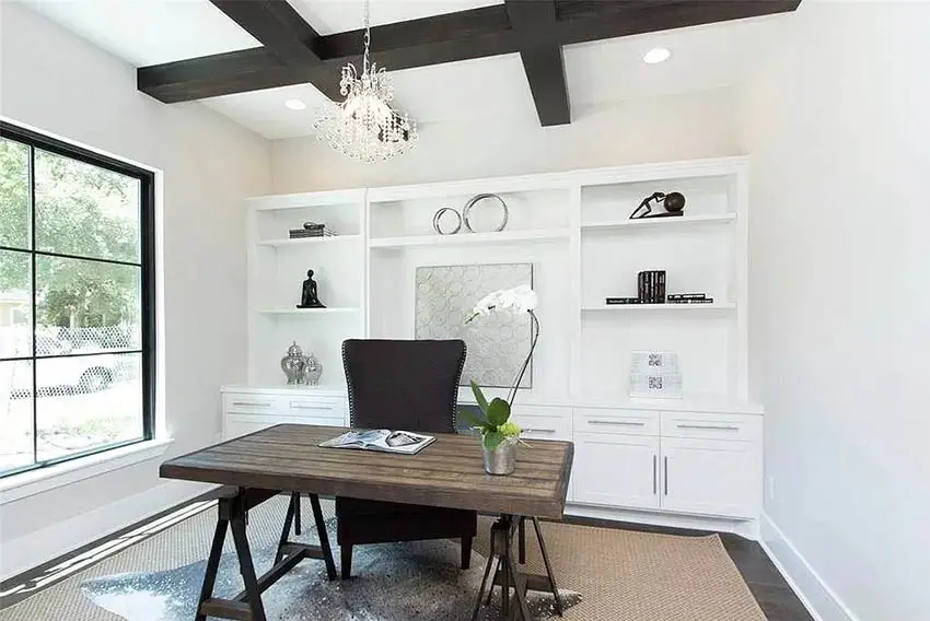 Coffered ceiling, crystal chandelier and orchid plant on the desk