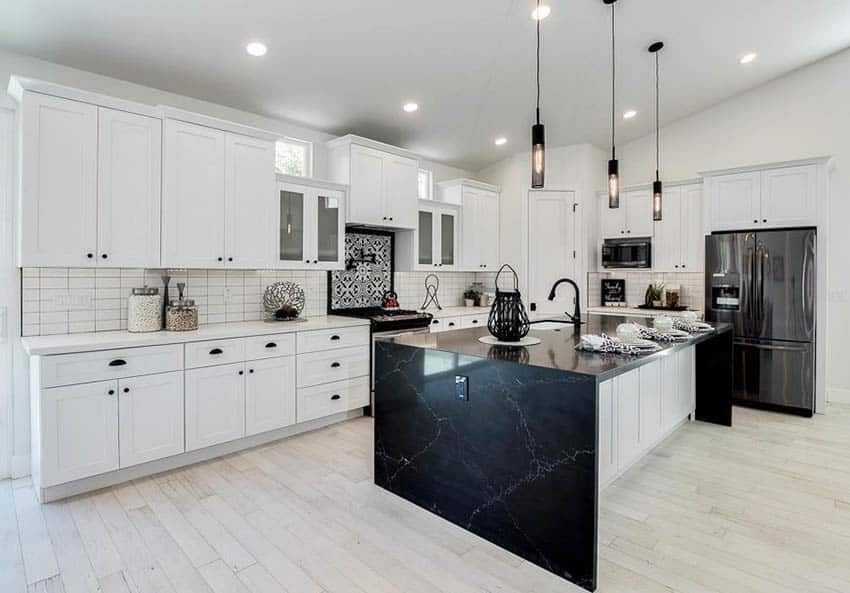 Contemporary kitchen with black quartz countertop island, white quartz and white cabinets
