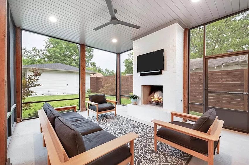 Enclosed design patio with fireplace, tv and ceiling fan