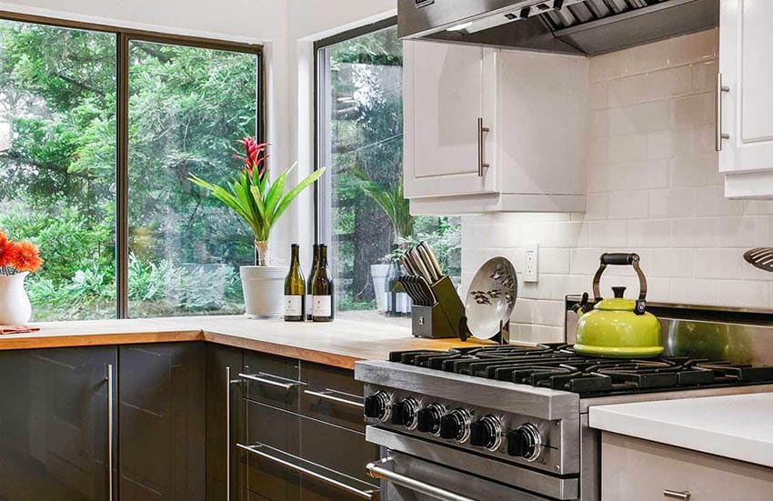 Kitchen corner window with bright colorful plants
