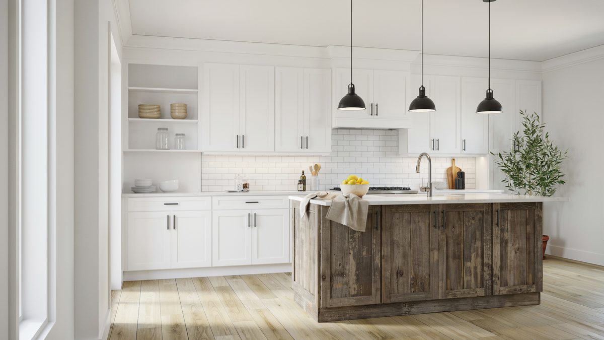 White kitchen with weathered barn wood island and black pendant lights