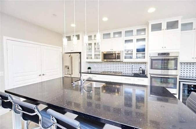 Kitchen with black galaxy quartz countertops white cabinets