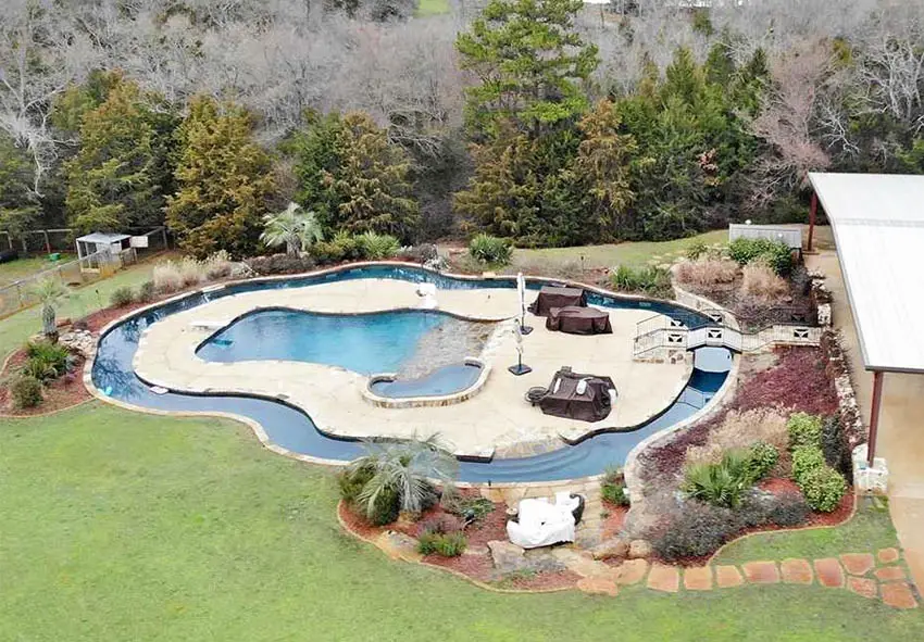 Large lazy river with middle pool island in backyard