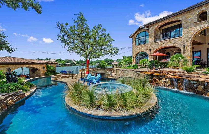 Lazy river pool with water feature, waterfall and hot tub island