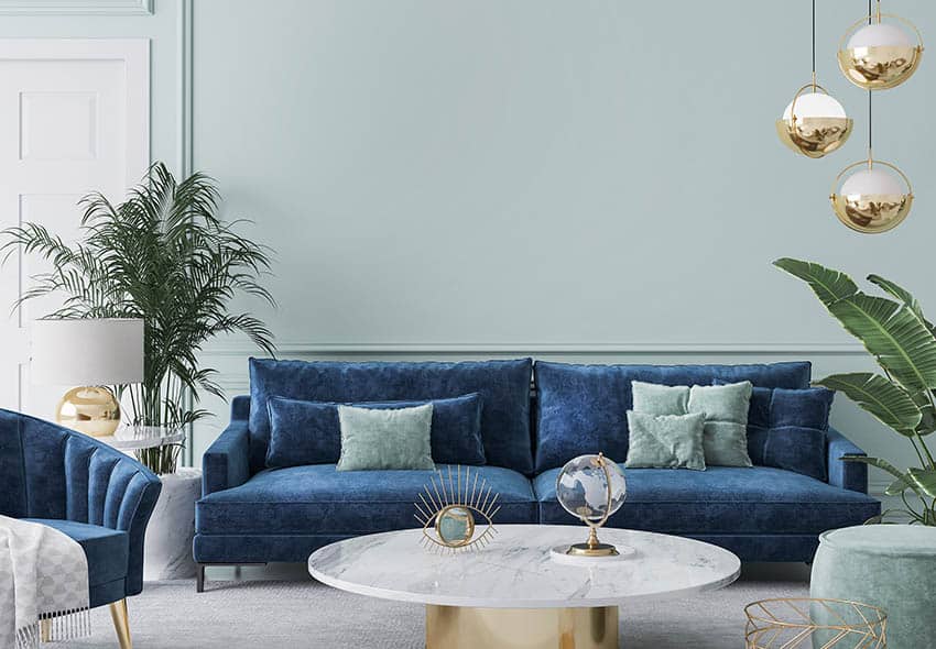 Living room with dark blue sofa mint green wall paint gray carpet flooring
