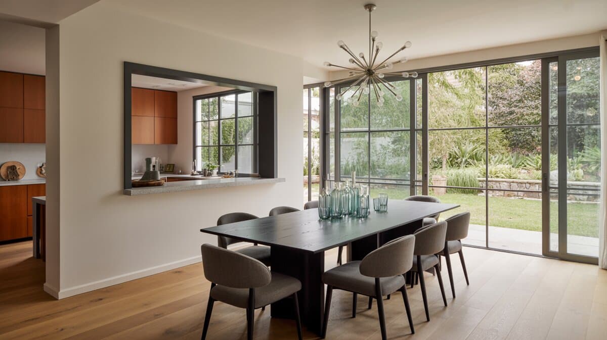 Modern dining room with sputnik chandelier garden windows and kitchen pass through wall cutout