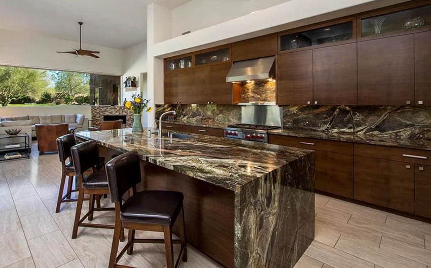 Modern kitchen with black and gold quartz countertops, waterfall island and dark brown cabinets