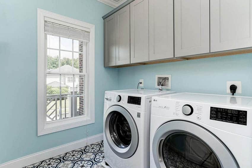 Pretty laundry room with front load washer dryer built in cabinets