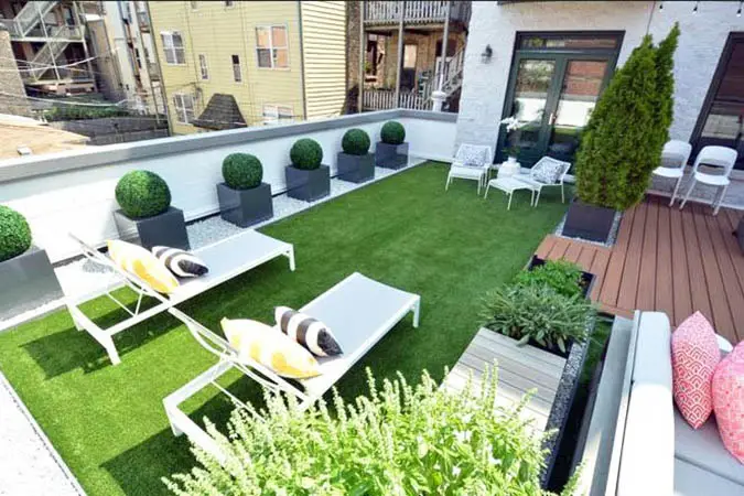 Rooftop patio with artificial grass and lounge chairs