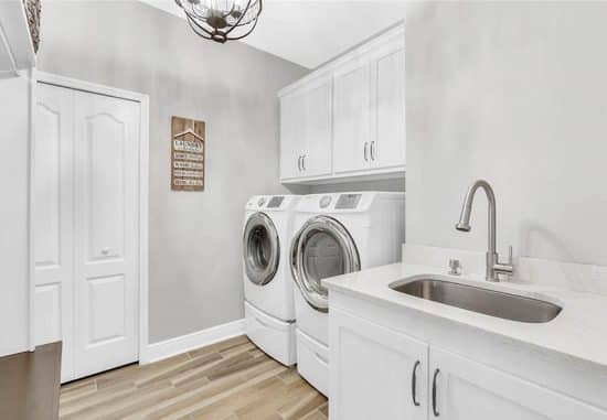 Stylish Laundry Room With Front Load Washer And Dryer With Built In Cabinets 550x381 