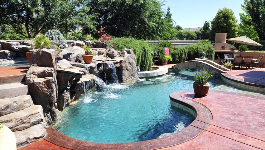 Swimming pool with grotto water feature and lazy river with bridge