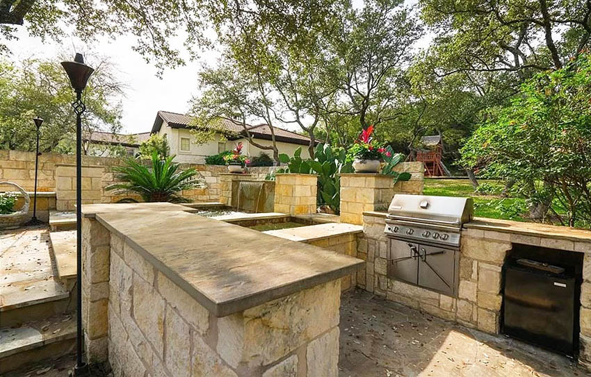 U shaped outdoor kitchen with concrete countertop