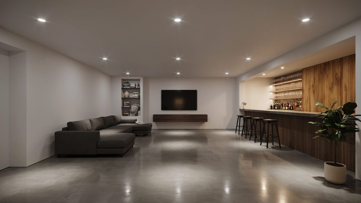 Finished basement lounge with polished concrete floor and wood paneled bar