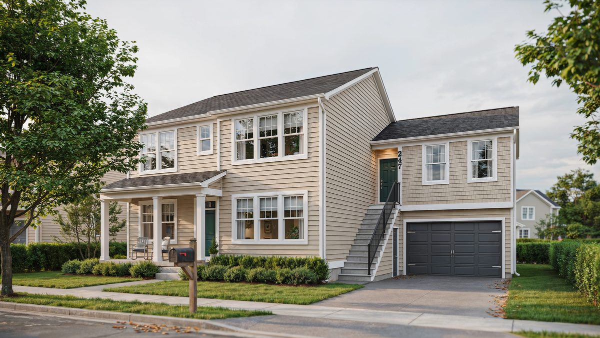 Two story home with exterior stairs to apartment above the garage