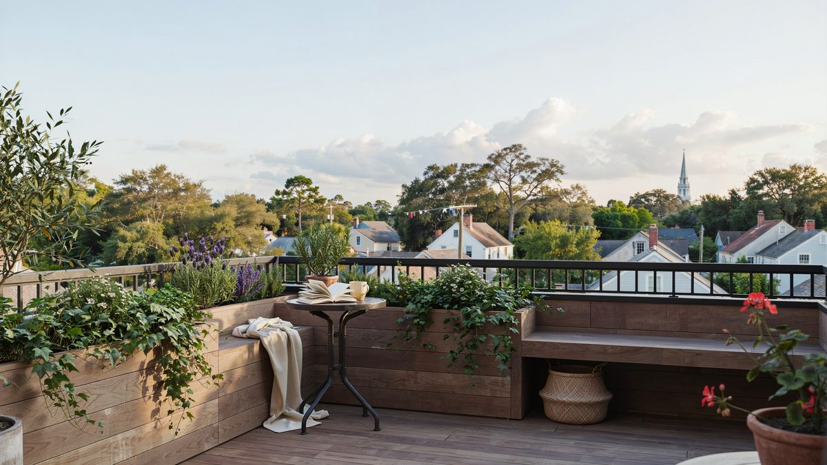 Raised deck with planter boxes, bistro table and rooftop village views