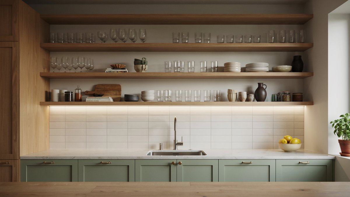 Open wood shelving with under shelf lighting above green cabinets and white backsplash