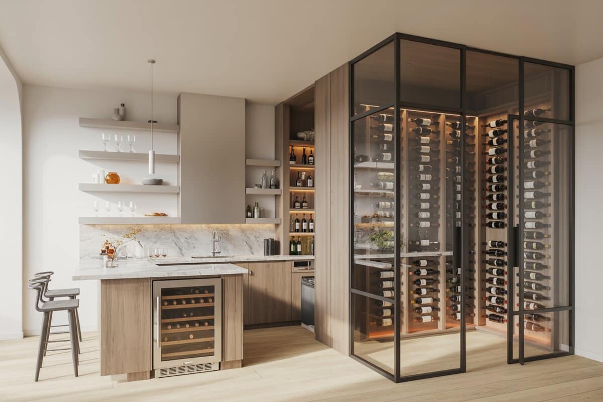 Marble home bar with stainless wine fridge beside a glass wine room