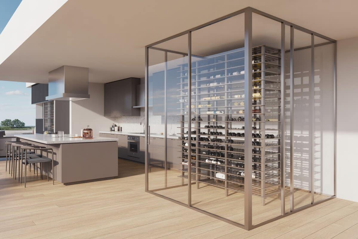 Metal-framed glass wine cube beside a gray kitchen near terrace windows