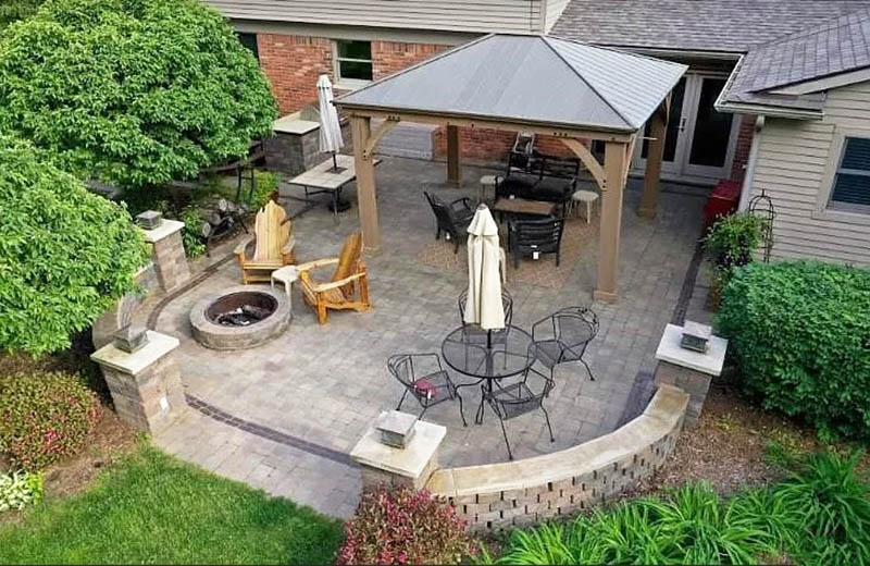Backyard paver patio with wall fire pit and pavilion