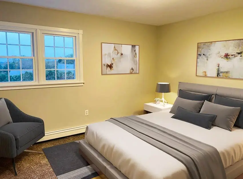 Bedroom with yellow paint and gray decor