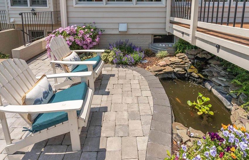 Concrete paver sitting area with small fish pond