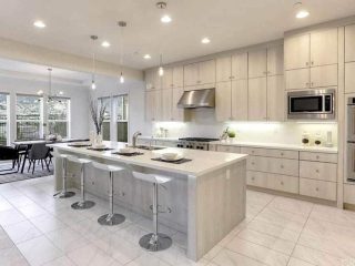 Contemporary kitchen with bleached color cabinets under cabinet lighting white quartz countertops
