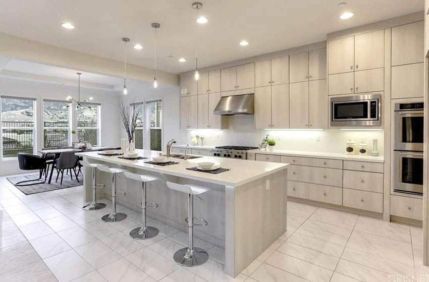 Contemporary kitchen with bleached color cabinets, under cabinet lighting and white quartz countertops