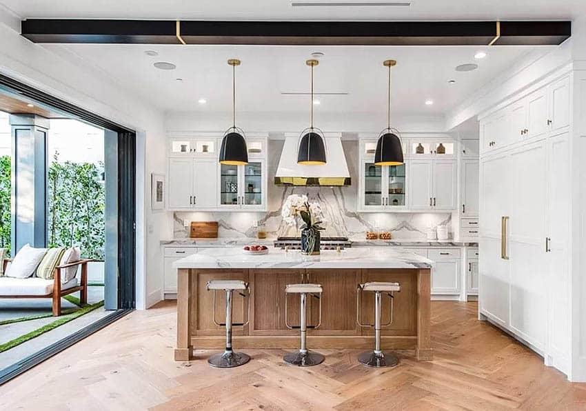 Contemporary kitchen with island seating, quartz countertops, white cabinets and black pendant lights