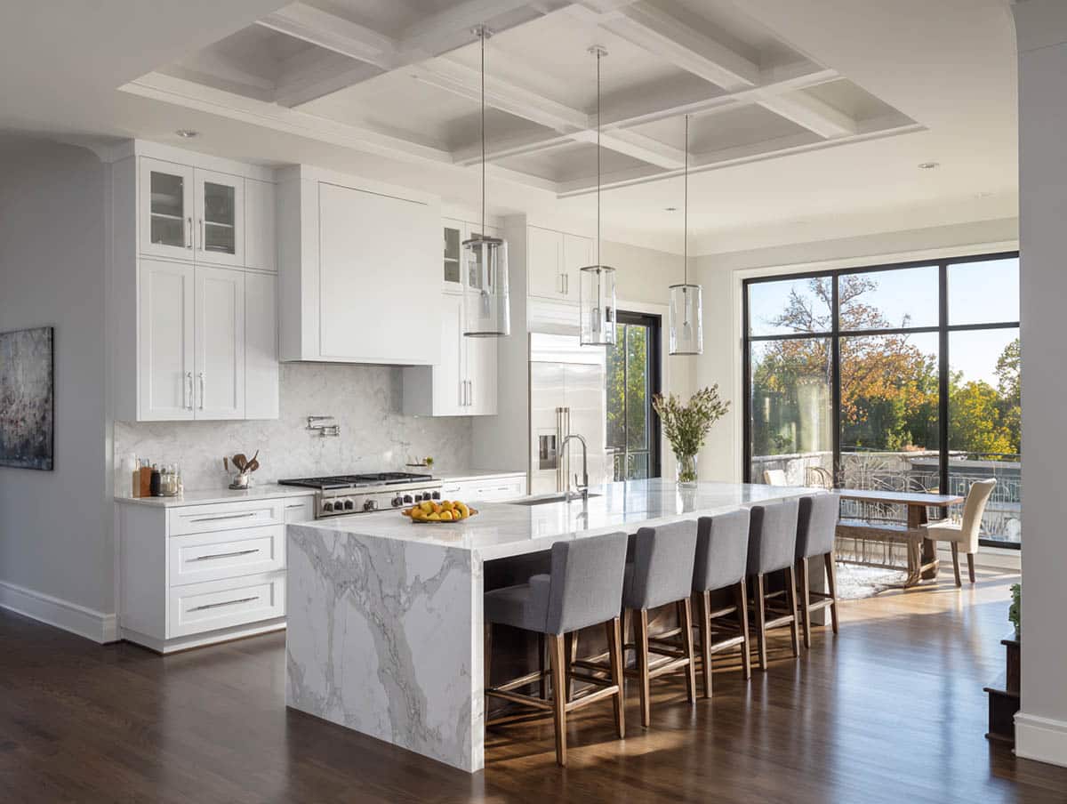 White colored kitchen cabinets with dark floors