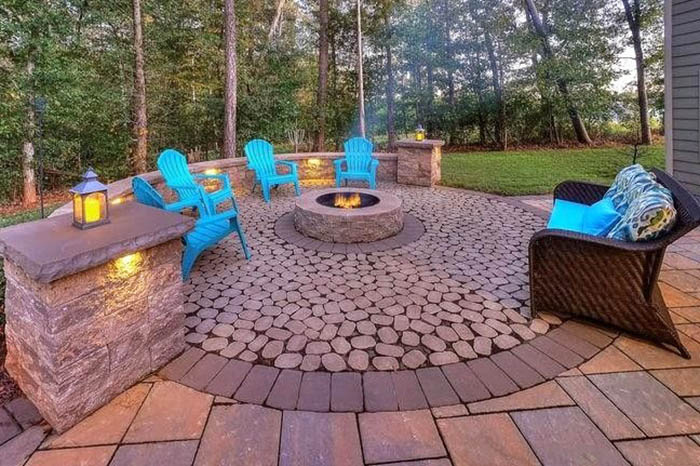 Custom circular paver patio with fire pit stone bench with lighting