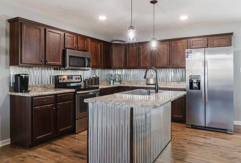 Kitchen With Corrugated Metal Backsplash And Island With Wood Cabinets 768x520 