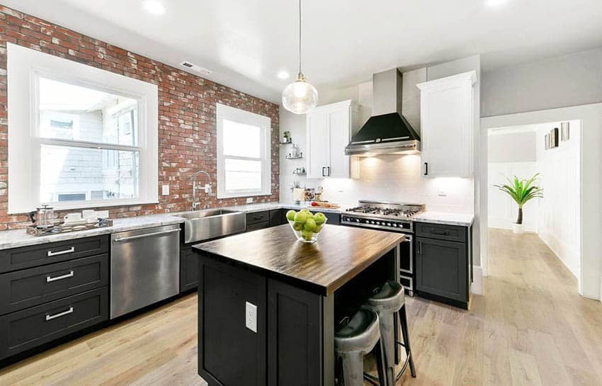 Kitchen with glass mosaic backsplash and black cabinets with chrome pulls