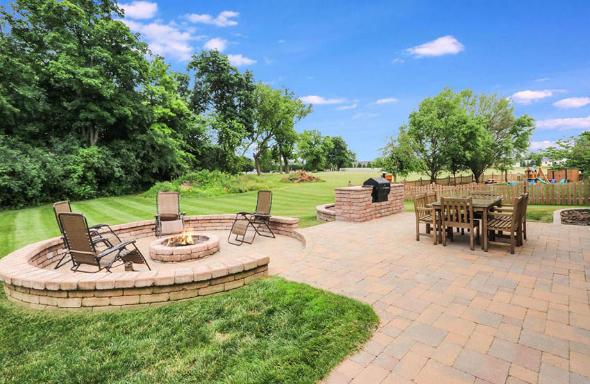 Large paver patio with outdoor dining and fire pit