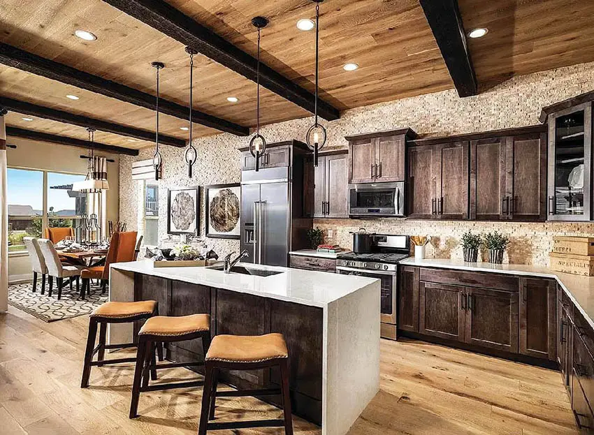 Kitchen with exposed beam ceiling, dinner chairs and white counter