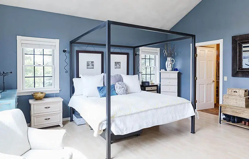 Master bedroom with blue paint and four post bed