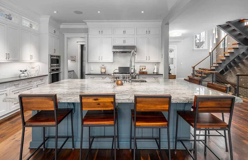 Modern farmhouse kitchen with blue island, seating for four, quartz countertops and white cabinets