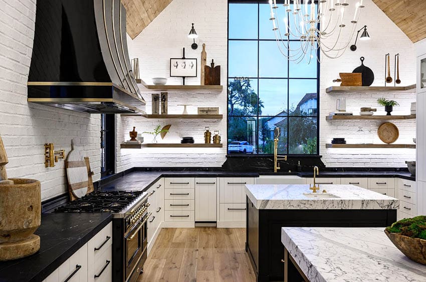 Kitchen with white plank cabinets, black island base and quartz two-tier countertops