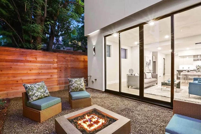 Modern house with gravel patio and firepit