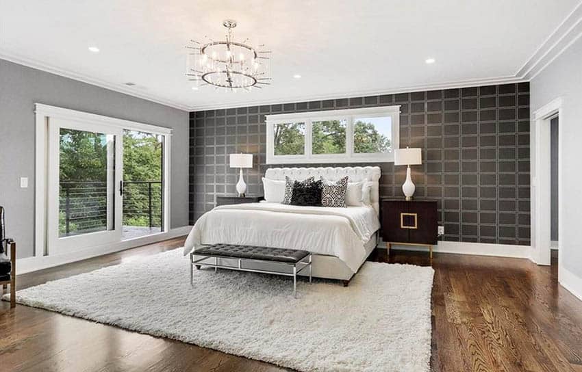 Modern master bedroom with wallpaper accent wall and area rug