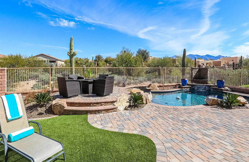 Raised paver patio with sitting area and small pool