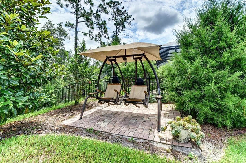 Small paver patio with swinging bench