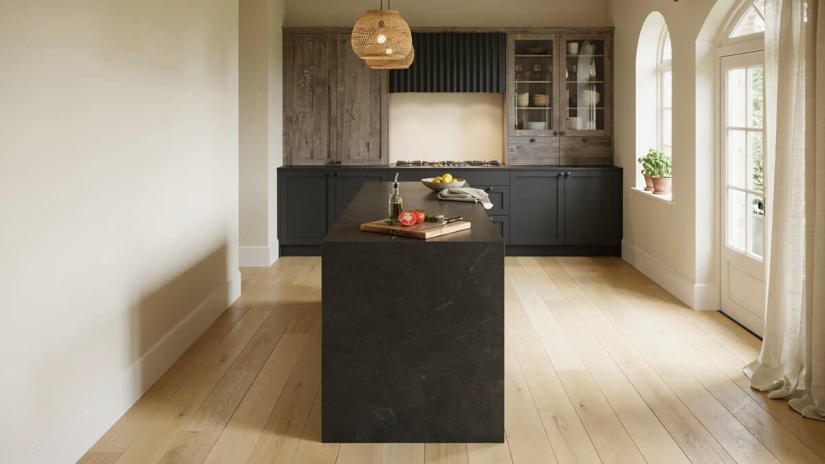 Dark soapstone islands, charcoal cabinets, distressed wood uppers, rattan pendant lights