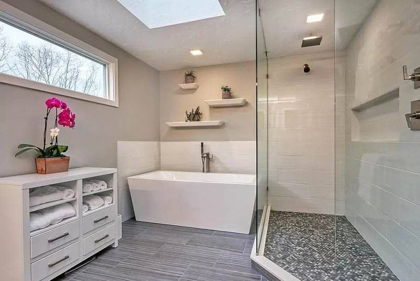 Bathroom with skylight and clerestory window with freestanding tub walk in shower