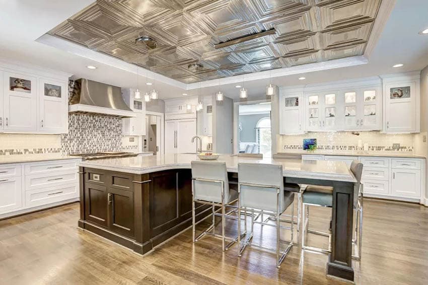 Beautiful transitional kitchen with white cabinets t shaped island metal tin ceiling