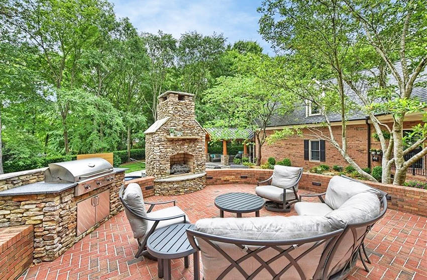 Brick patio with fireplace and outdoor kitchen