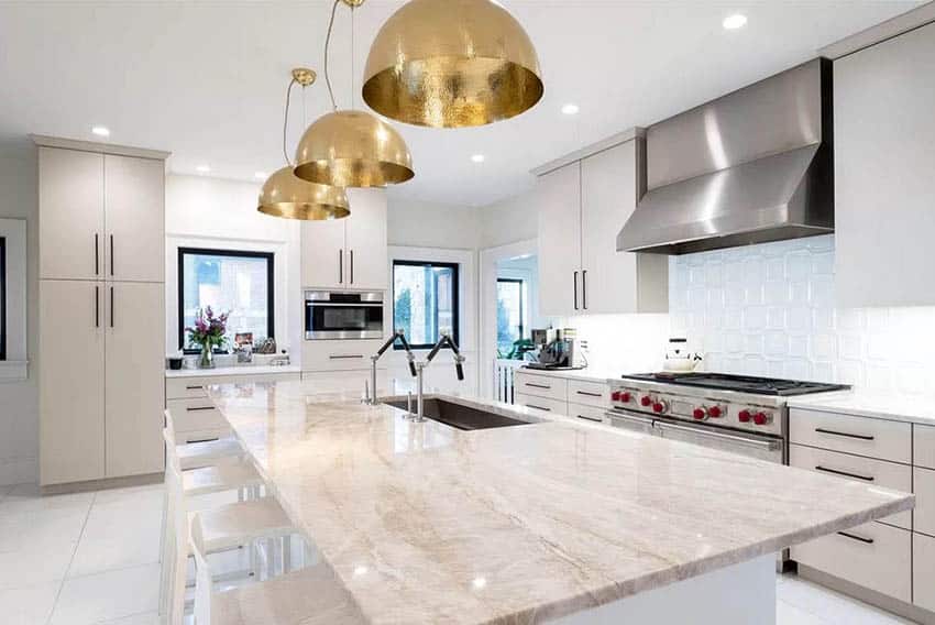 Kitchen with marble countertop, island and gold pendant lights