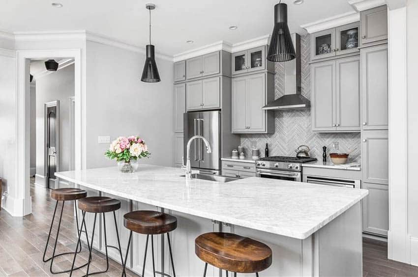 Contemporary kitchen with marble countertops and gray cabinets