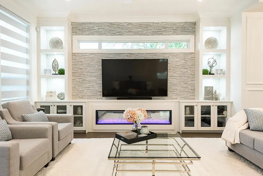 Contemporary living room with lighted recessed wall niches and stacked stone gas fireplace